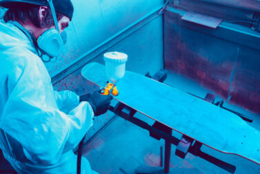 Skater in process of making his own skateboard, longboard - open business concept