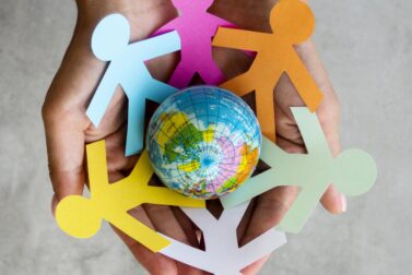 top-view-origami-chain-people-with-globe